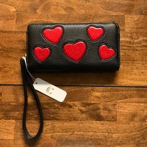 Black vinyl clutch wristlet distributed by Charging Charlie of Huston Tx